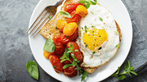 fried eggs with cooked cherry tomatoes and toast